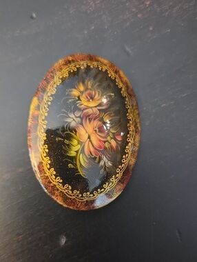 Vintage '96 Oval Black Floral Brooch with Gold Accents